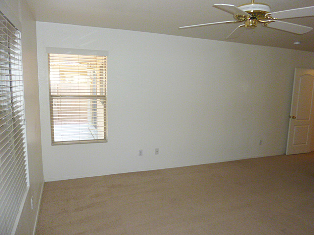 Private master bedroom windows look out over backyard